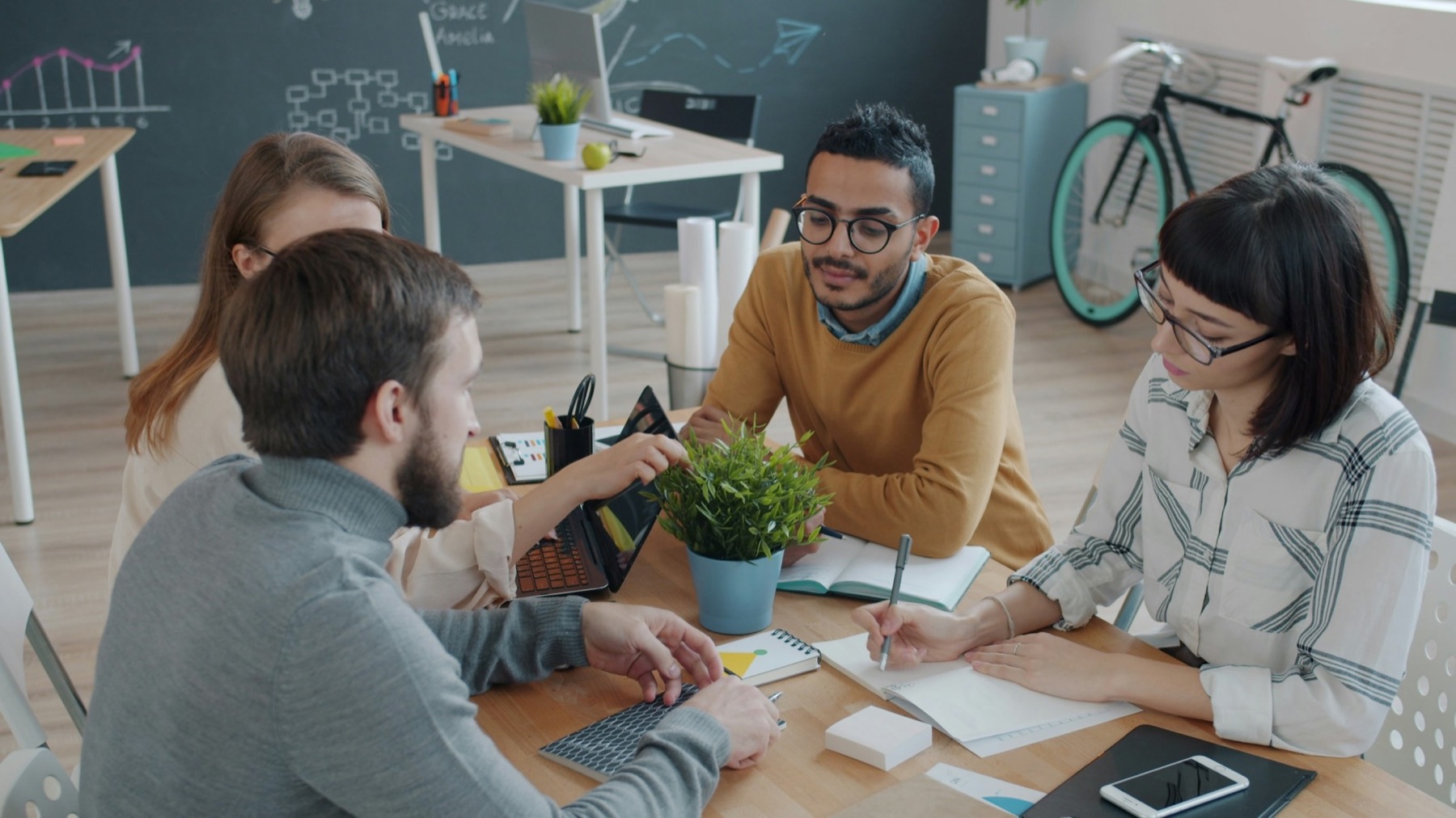 Four colleagues planning at a table